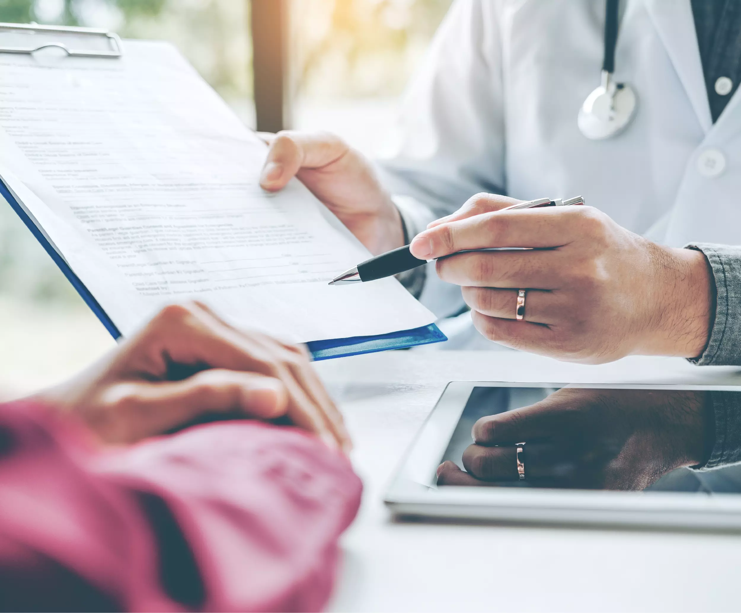 Doctor reading form to patient