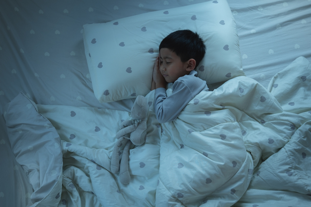 child sleeping in bed