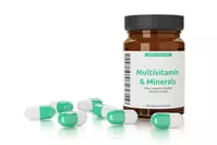 multivitamin bottle and capsules