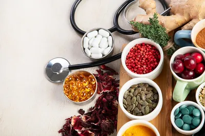 holistic health represented by stethoscope, supplements, herbs, and whole foods
