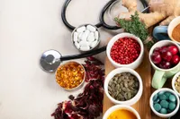 holistic health represented by stethoscope, supplements, herbs, and whole foods